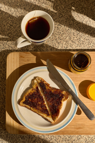 Toast with yeast extract spread with cup of tea. - Australian Stock Image