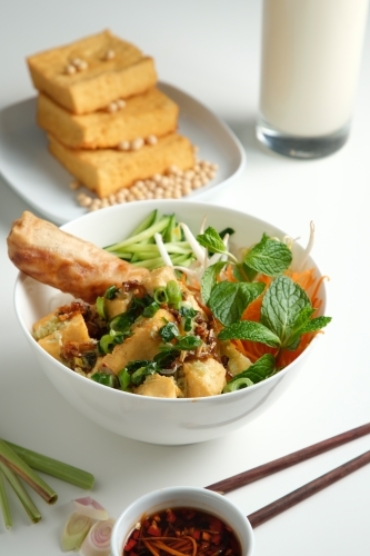 Tofu Bun Cha Gio bowl with topped with fried spring roll. - Australian Stock Image