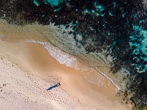 Top down view of lone person walking along sand on North Beach, WA