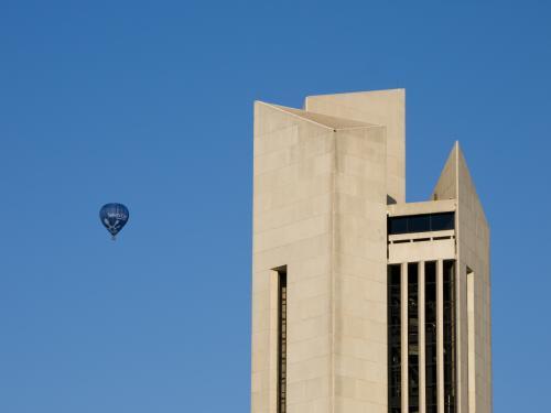 Top of the National Carillon tower with a hot air balloon beside - Australian Stock Image