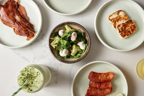 Top shot of meat, salad and a drink served in a cafe. - Australian Stock Image