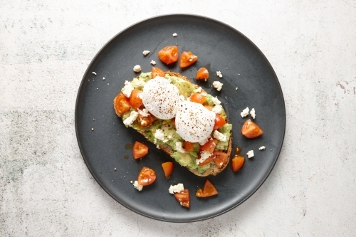 top shot of smashed avocado with poached eggs - Australian Stock Image