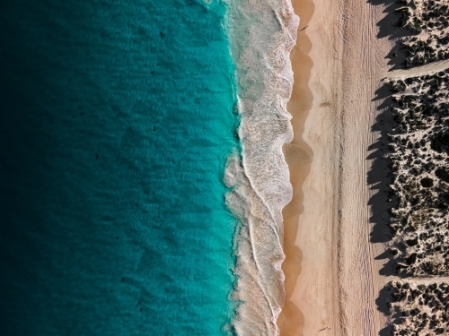 top shot of Summers in Perth with white sand, green grass and ocean water