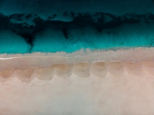 top shot of Summers in Perth with white sand, waves and ocean water - Australian Stock Image
