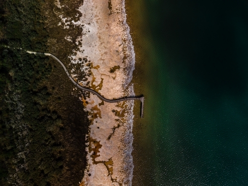 top view shot of a beach walkway with bushes and trees on a sunny day - Australian Stock Image