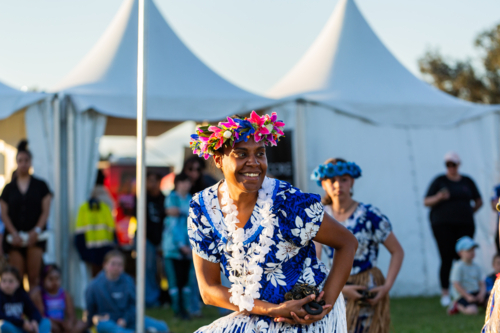 Torres Strait Islander woman dancing and performing at cultural spectacular event - Australian Stock Image