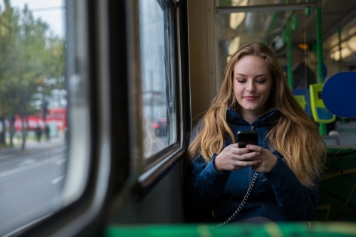 Tourist Texting on the Tram - Australian Stock Image
