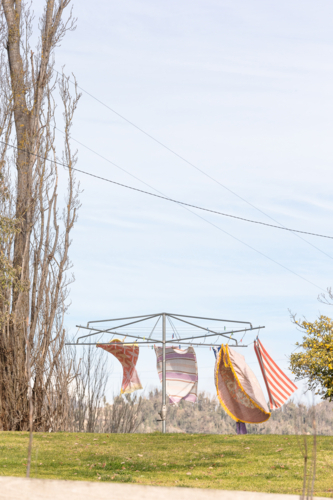Towels hanging in a rotary clotheslline outdoors - Australian Stock Image