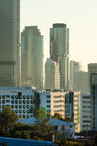 Towers and skyscrapers of Brisbane city on a slight hazy morning, backlit by sunlight. - Australian Stock Image
