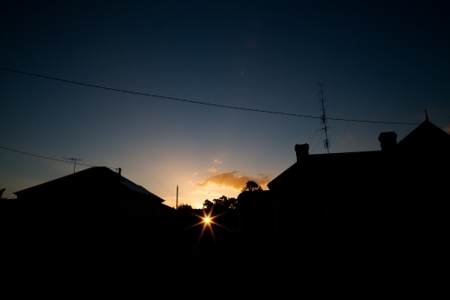 Town house buildings silhouetted against sunset - Australian Stock Image