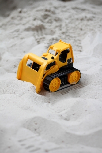Toy bulldozer in sandpit - Australian Stock Image