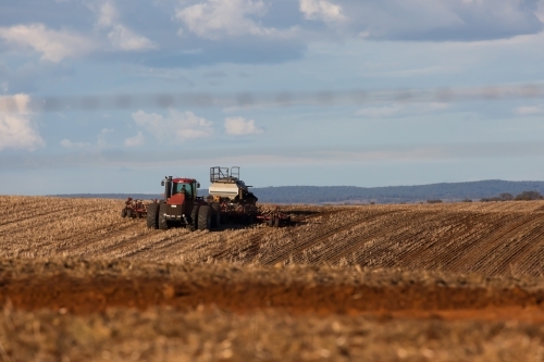 tractor ploughing soil in a dry paddock