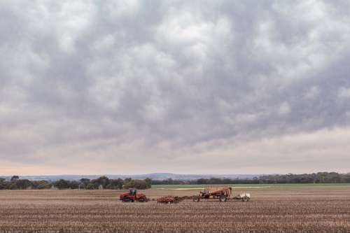 Tractor seeding paddock on an overcast day - Australian Stock Image