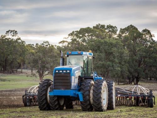Tractor with air-seeder sowing crop in a paddock - Australian Stock Image