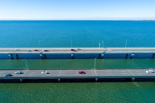 Traffic driving on two bridges over water. - Australian Stock Image