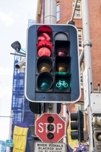 Traffic light signal with green cycle lamp and red stop and red right turn signal illuminated - Australian Stock Image