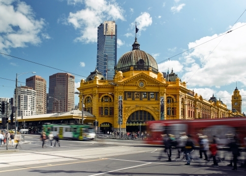 Trams and pedestrians at Flinders Street Station - Australian Stock Image