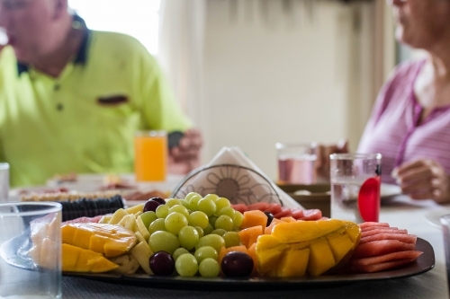 Tray of fruit with people in background - Australian Stock Image