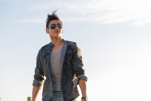 Trendy hispanic man walking to camera - Australian Stock Image