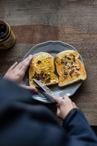 tween girl making toast in the morning - Australian Stock Image