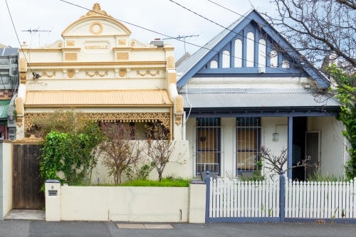 Two colourful terrace houses with ornate brightly coloured facades