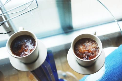 Two cups of coffee on a table from above - Australian Stock Image