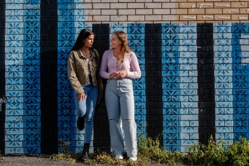 two friends hanging out in an urban setting - Australian Stock Image