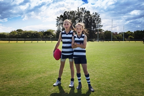 Two girl team players in AFL football - Australian Stock Image