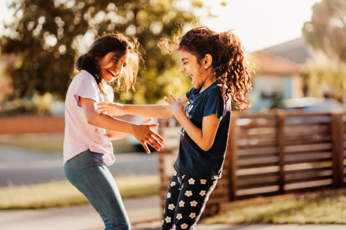 two girls playing in the neighbourhood - Australian Stock Image