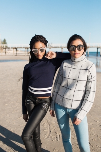 Two girls posing on a beach - Australian Stock Image