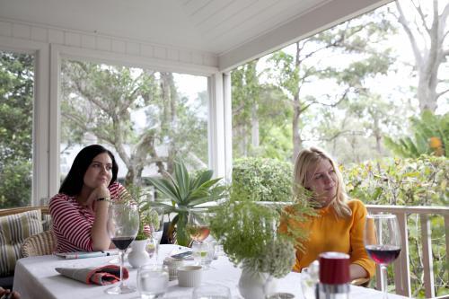 Two girls sitting at lunch on verandah - Australian Stock Image