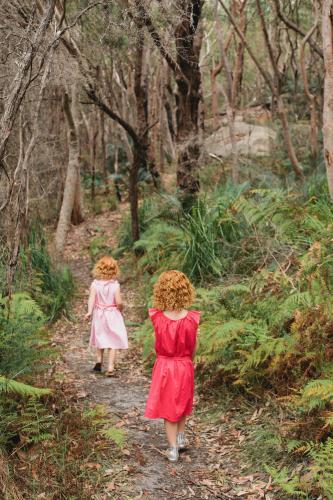 Two girls walking along a bush track - Australian Stock Image