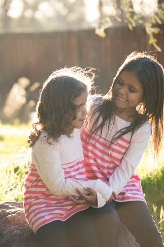 Two happy Aboriginal girl sisters - Australian Stock Image