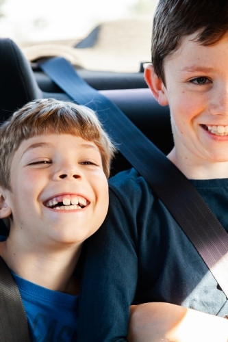 Two happy boys laughing together in the car - Australian Stock Image