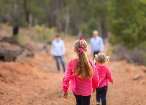 Two little girls and their parents outdoors - Australian Stock Image