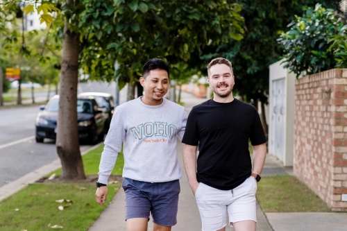 two men walking on the footpath - Australian Stock Image