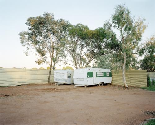 Two old caravans parked in dusty, remote caravan park - Australian Stock Image