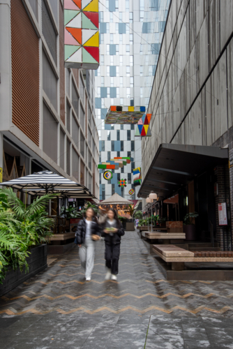 Two people in Steam Mill Lane, Darling Harbour on a wet day - Australian Stock Image