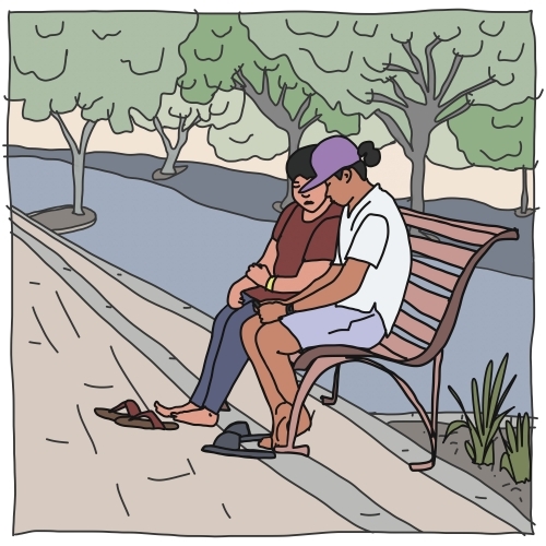 Two people of asian decent sitting on street bench with thongs off