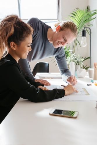 Two people working on a house design together - Australian Stock Image