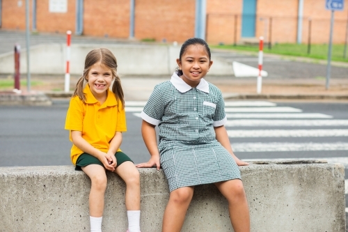 Two public school friends sitting together before school