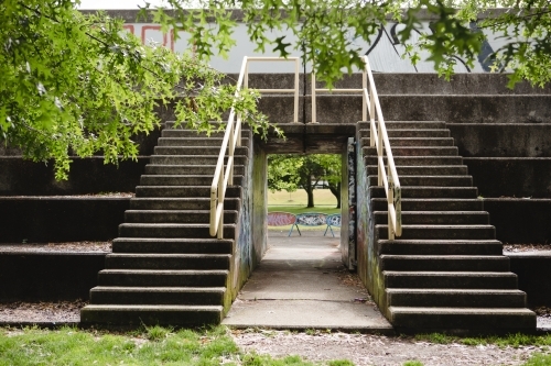 Two sets of outdoor steps separated by a tunnel