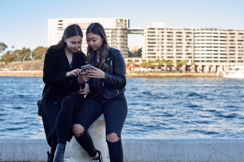 Two sisters spending time together harbourside - Australian Stock Image