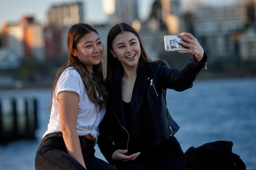 Two sisters spending time together harbourside - Australian Stock Image