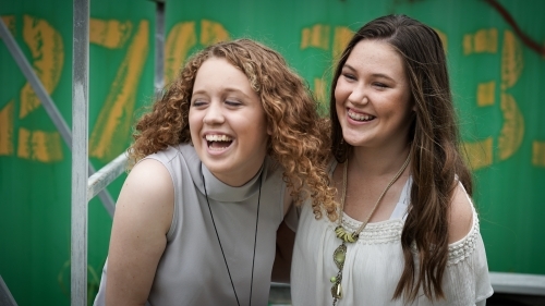 Two teenage girlfriends laughing - Australian Stock Image