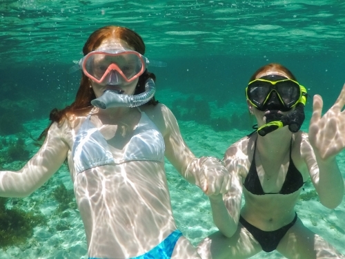 Two teenage girls snorkelling in an ocean rock pool - Australian Stock Image