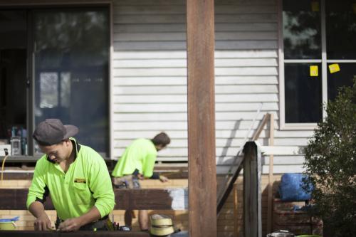 Two tradesmen work on home renovations. - Australian Stock Image