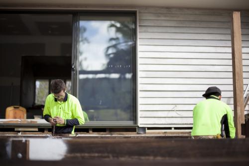 Two tradesmen work on home renovations.