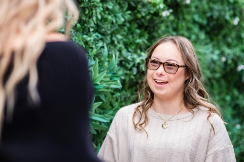 two woman talking, from a series featuring a young woman with Down Syndrome