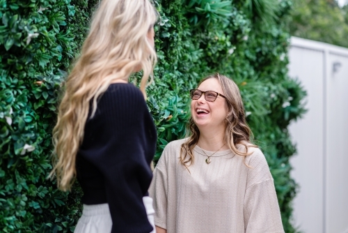 two woman talking, from a series featuring a young woman with Down Syndrome - Australian Stock Image